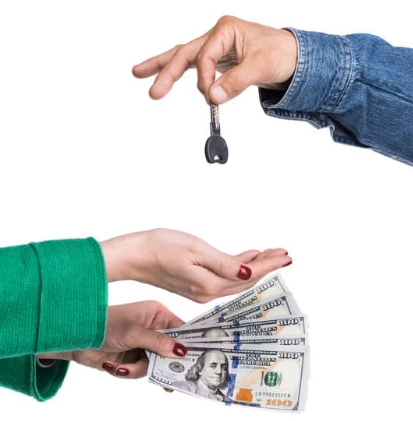 person handing keys to a person with cash